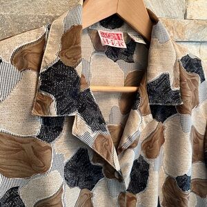HER vintage blouse or jacket. Small removable shoulder pads. Probably polyester.